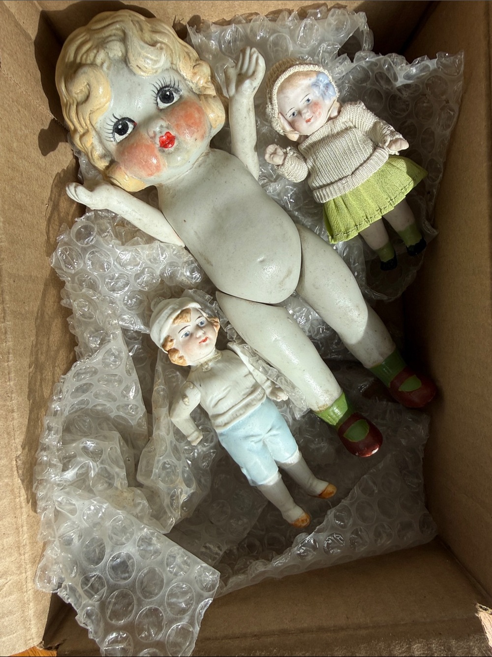 Source Unknown Porcelain Doll Group with Cream, Green and Red Accents
